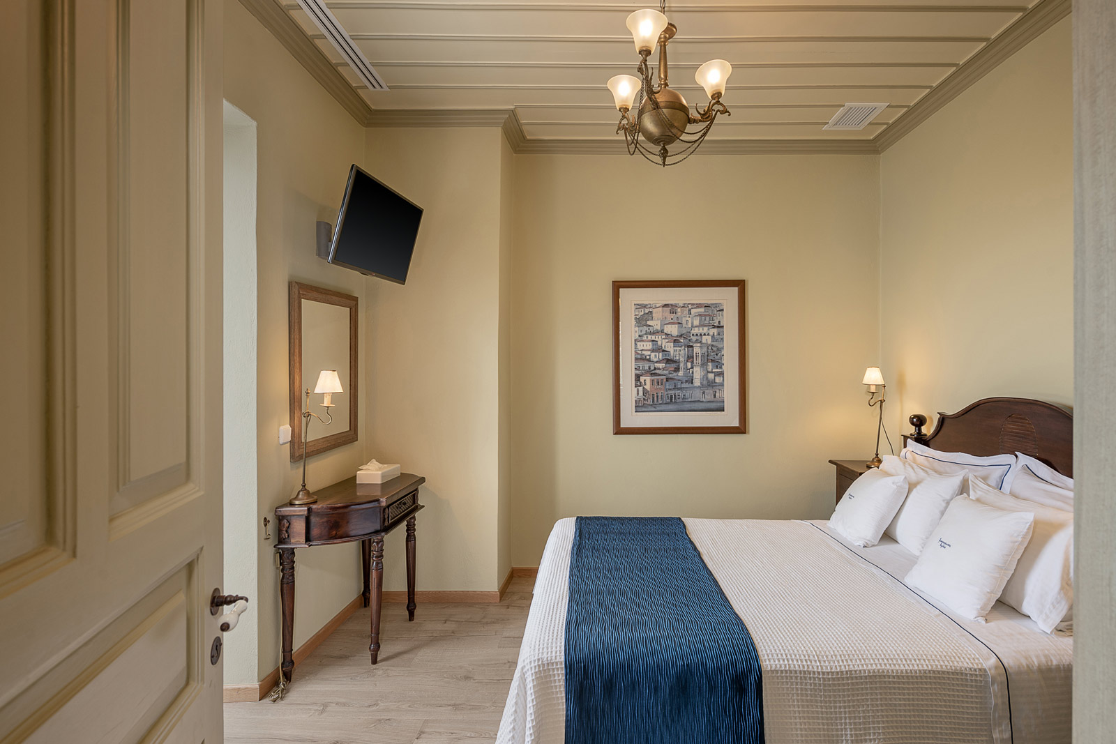 Autumn suite bedroom, with sbedside table, TV and vanity table.