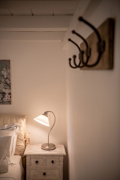 Moon suite bedroom, lamp light on bed.